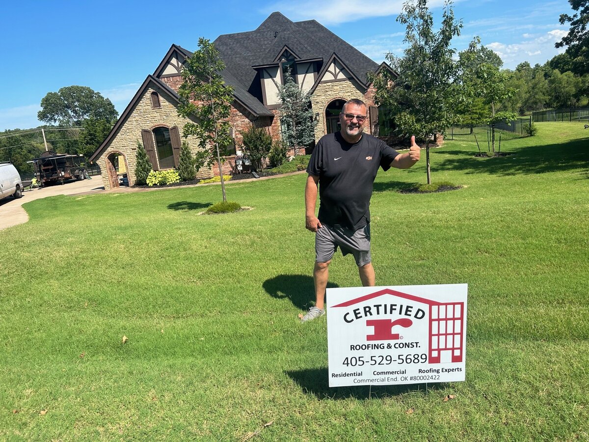 Certified Roofing contractor giving thumbs up in front of completed project in Edmond Oklahoma